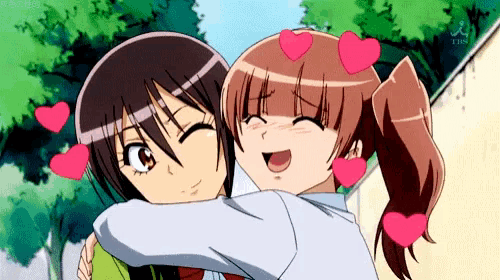 a couple of anime girls hugging each other with hearts surrounding them .
