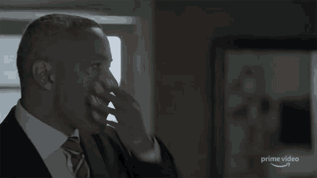 a man in a suit and tie is being shown on a prime video ad