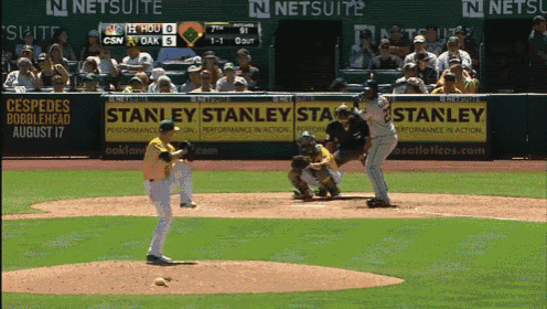 a baseball game is being played in front of a stanley advertisement