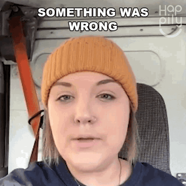 a woman wearing a beanie says something was wrong while sitting in a car