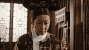 a woman in a traditional costume is standing in a room .