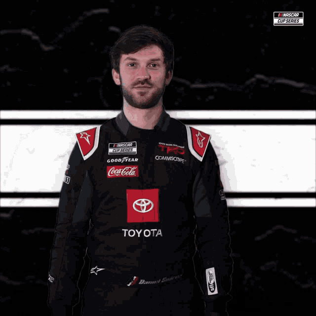 a man wearing a toyota and coca-cola uniform