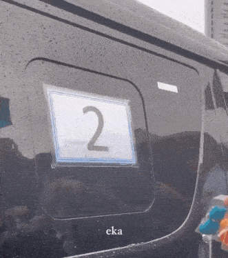 the number 2 is on the window of a black vehicle