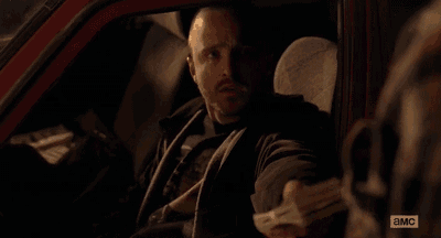 a man in a car is holding a piece of paper that says ' a & mc ' on it