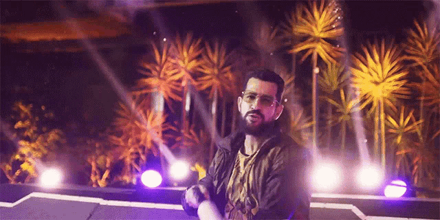 a man with a beard is standing on a stage in front of palm trees and purple lights