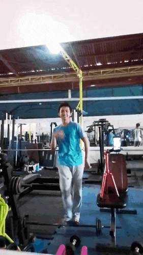 a young boy in a blue shirt is dancing in a gym