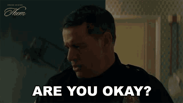 a man in a police uniform is asking are you okay