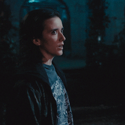 a woman wearing a black jacket and a t-shirt that says ' nightmare ' on it