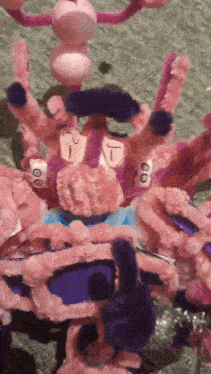 a spider made out of pipe cleaners with the letter t on its head
