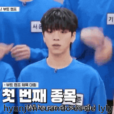 a man wearing a blue shirt with korean writing on the front