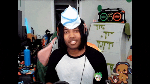 a man wearing headphones and a hat with a hamburger on top of his head