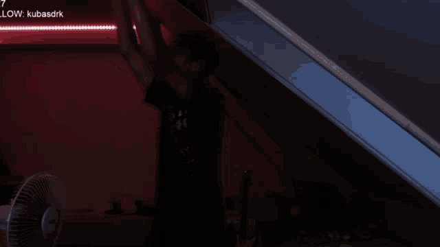 a man stands in a dark room with the words low kubasdrk on the top