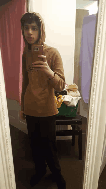 a person taking a selfie in front of a mirror with a samsung phone
