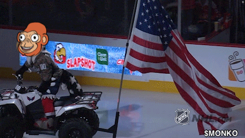 a monkey on a four wheeler with an american flag in front of a sign that says slapshot