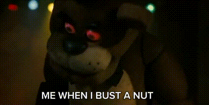 a stuffed animal is standing in the dark with the words `` me when i bust a nut '' written on it .