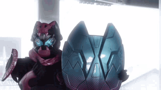 a robot is holding a blue shield with the letter m on it .