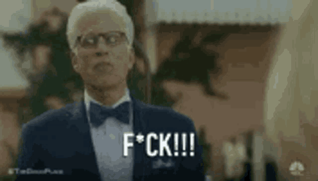 a man in a suit and bow tie is saying f * ck !!! .