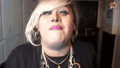 a close up of a woman making a funny face