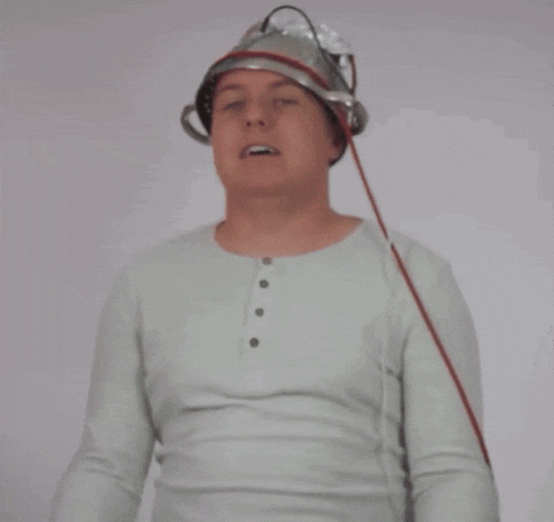 a man wearing a tin foil hat with a red cord