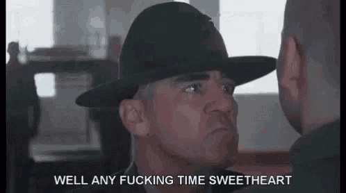 a soldier in a hat is talking to another soldier in a room .