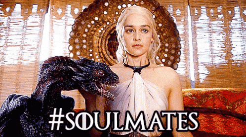 a picture of a woman holding a dragon with #soulmates written on it