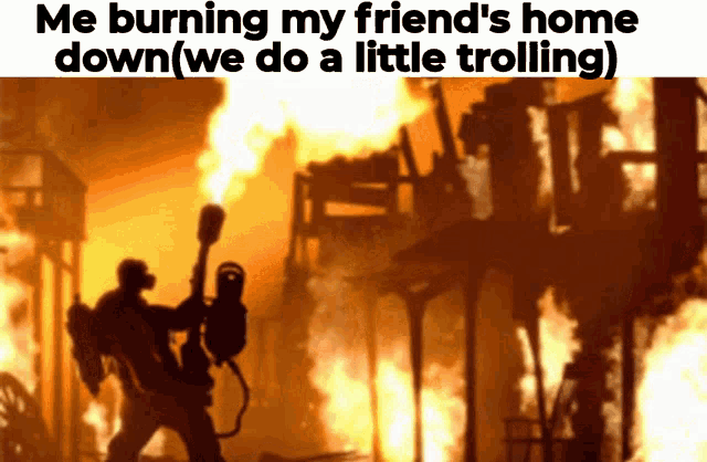 a man holding a torch is standing in front of a burning building