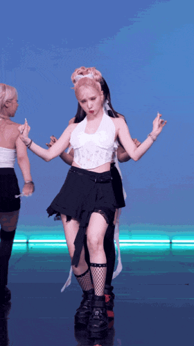 a woman in a white top and black skirt dancing