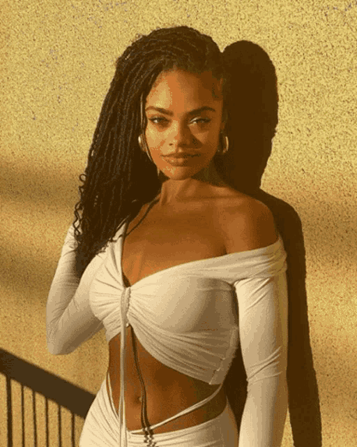 a woman wearing a white off the shoulder top
