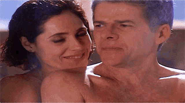 a man and a woman are having sex and the woman is smiling