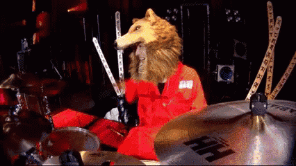 a person with a wolf head playing drums with a cymbal that says hf on it
