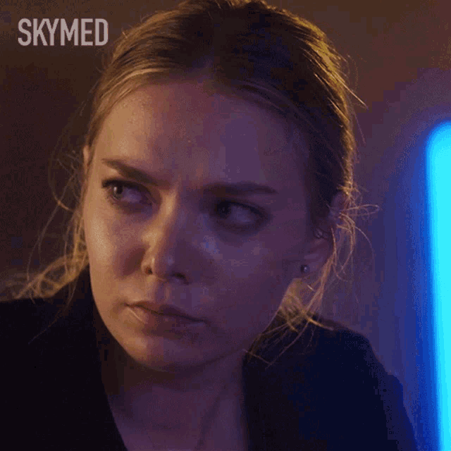 a close up of a woman 's face with the word skymed above her head