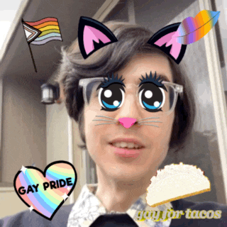 a man with cat ears and a heart with gay pride written on it