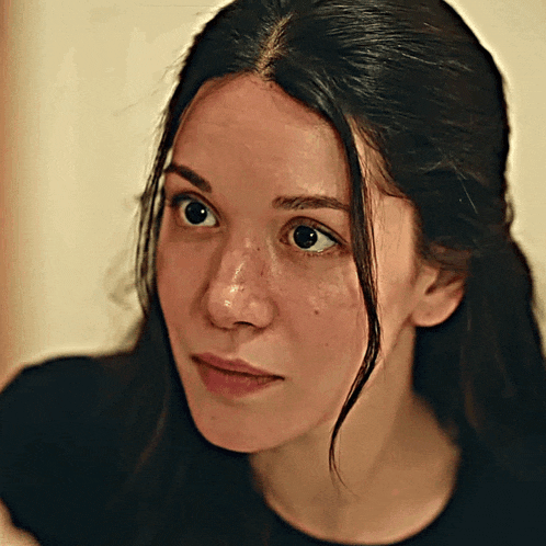 a close up of a woman 's face with dark hair