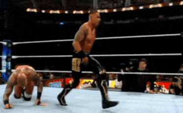 a man in a wrestling ring has a sticker on his shorts that says ' i am a fighter '