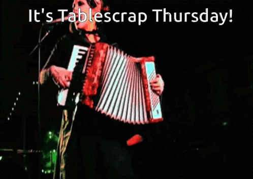 a woman singing into a microphone while playing an accordion with the words it 's tablescrap thursday below her