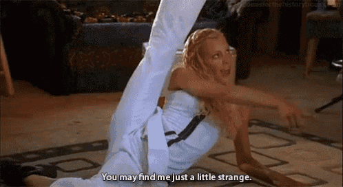 a woman is laying on the floor with her legs crossed and says `` you may find me just a little strange . ''
