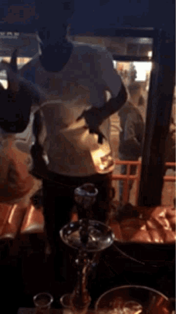 a man is smoking a hookah in front of a television