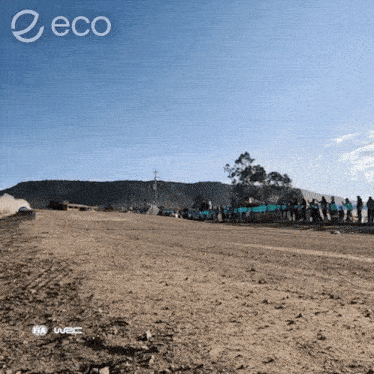 a group of people are standing on the side of a dirt road with the word eco on the bottom