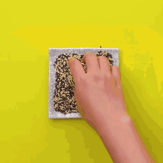 a chocolate sauce is being poured on a bagel with sesame seeds