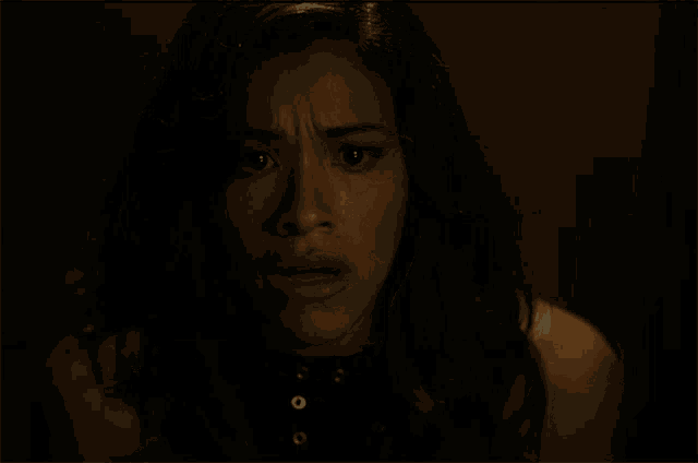 a close up of a woman 's face with a serious look on her face