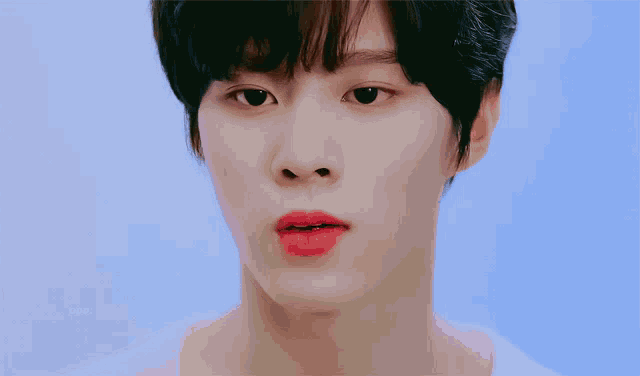 a close up of a person 's face with korean writing on the bottom left