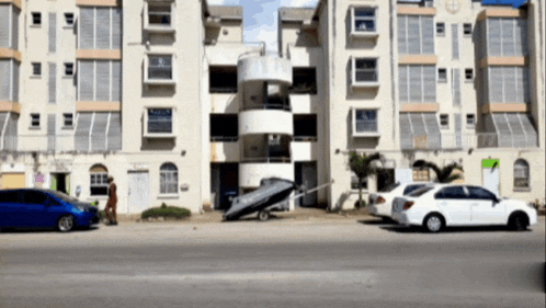 a white car is parked in front of a building