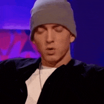 a close up of a man wearing a beanie and a black jacket .