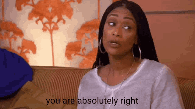 a woman sitting on a couch with the words " you are absolutely right " written below her