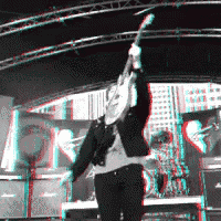 a man is playing a guitar on a stage with a red and blue background