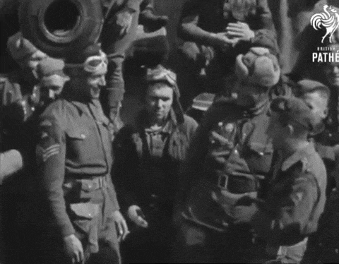 a black and white photo of a group of soldiers with the word pathe on the bottom right