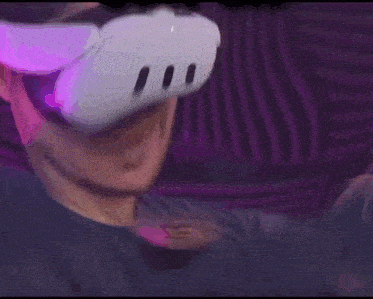 a man wearing an oculus rift virtual reality headset is holding a controller .