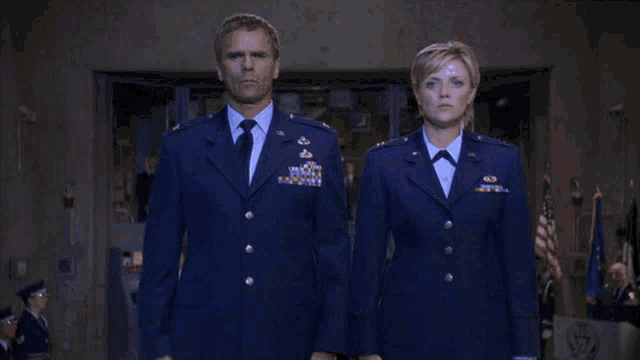 a man and a woman in military uniforms saluting