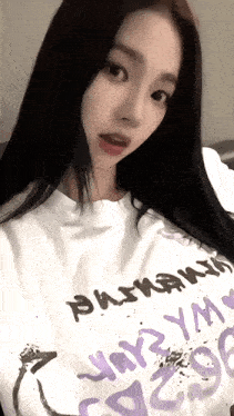 a woman wearing a white t-shirt that says " phoenix " on it