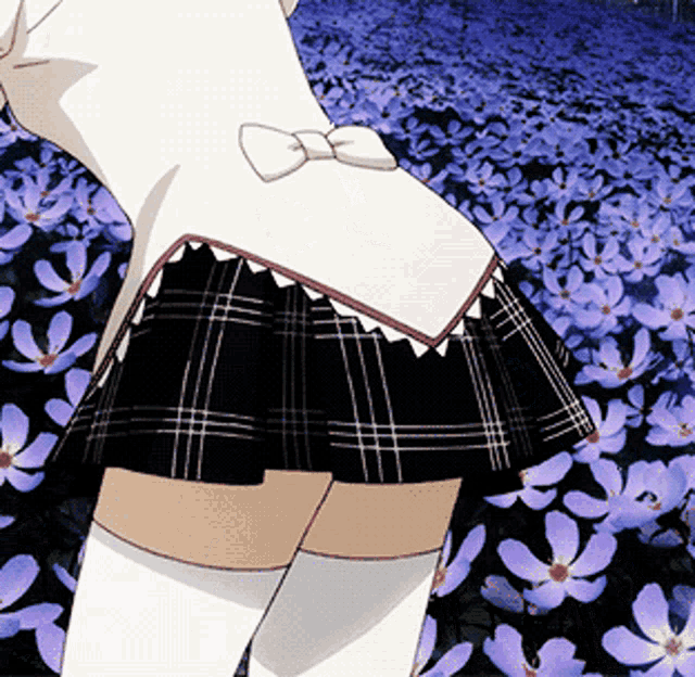 a girl in a plaid skirt and white knee high socks stands in a field of purple flowers
